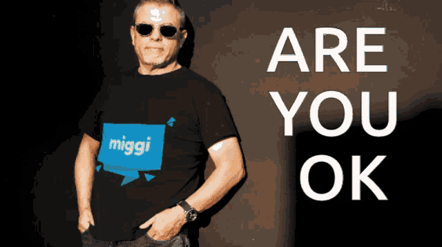 a man wearing a shirt that says miggi on it