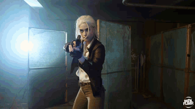 a woman holding a gun in front of a sign that says ' body floor ' on it