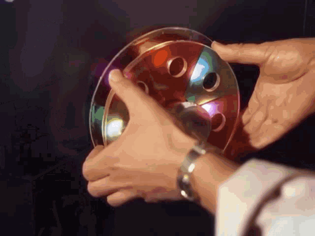 a close up of a person 's hands holding a round object