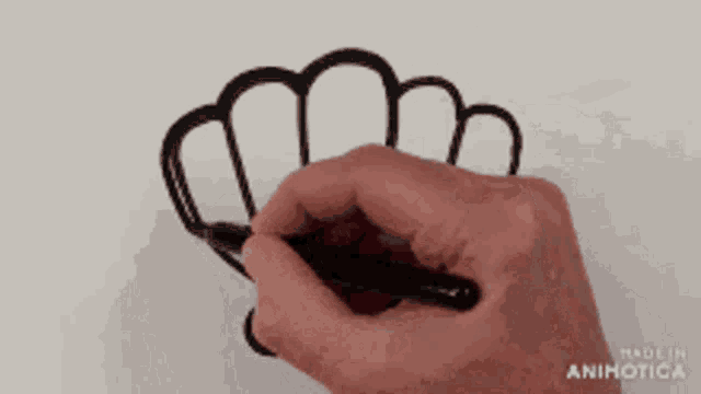 a hand is drawing a chef hat with a marker and the words made in animatica are visible