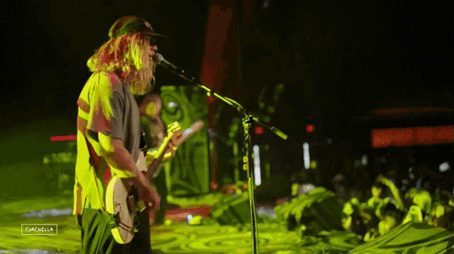 a man playing a guitar and singing into a microphone with a caption that says " gazelle "