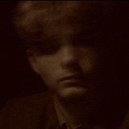 a close up of a person 's face in the dark