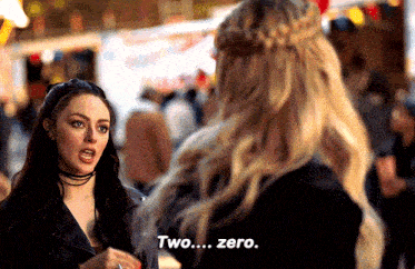 two women are standing next to each other and one of them is saying two ... zero