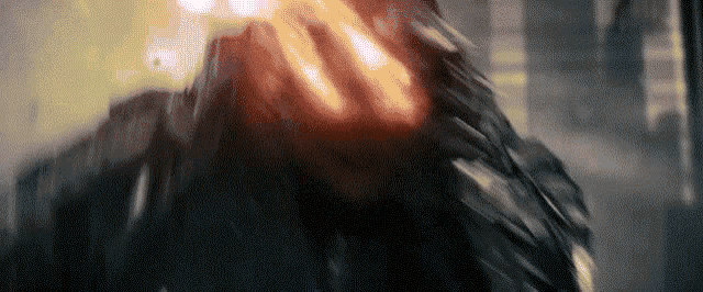 a close up of a person 's face with a red light coming out of their mouth .