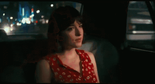 a blurry picture of a person in a car with a rear view mirror that says ' l. ' on it