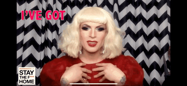 a drag queen says " i 've got " while wearing a red dress