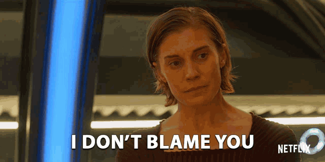 a woman says " i don 't blame you " in front of a blue light