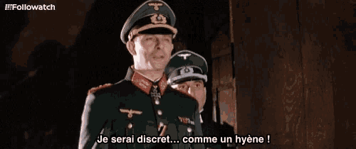 two men in military uniforms are standing next to each other and one says je serai discret comme un hyene