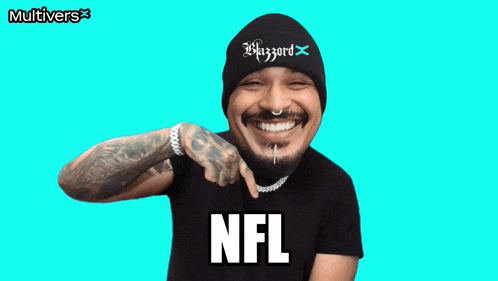 a man wearing a beanie and a nfl shirt smiles