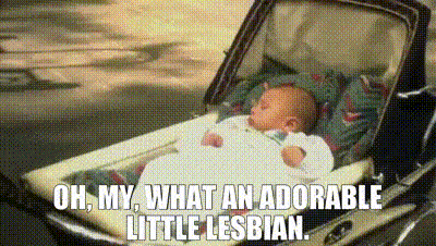 a baby is laying in a stroller with the words `` oh my what an adorable little lesbian '' .