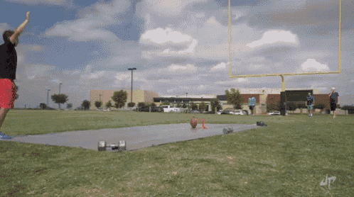 a man is throwing a ball in a field with the letter dp on the bottom