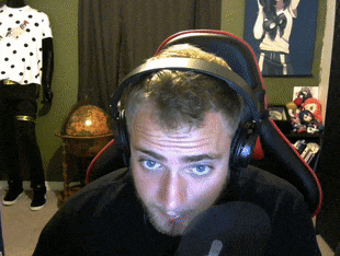 a man wearing headphones is sitting in a chair in front of a microphone