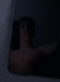 a man is taking a selfie in a dark room .