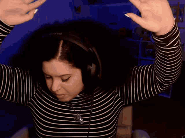 a woman wearing headphones has the word aleluya written on her shirt