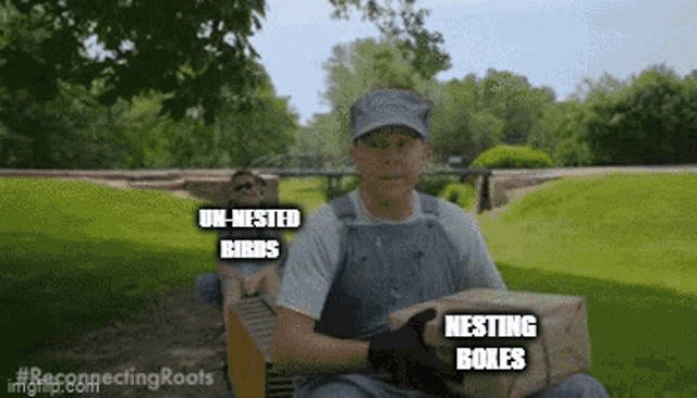 a man in overalls is holding a box that says nesting boxes on it