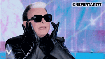 a man wearing sunglasses and leather gloves is making a face