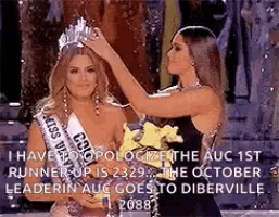 a woman is putting a crown on another woman 's head at a pageant .