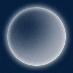 a white circle is glowing in the dark on a dark background .