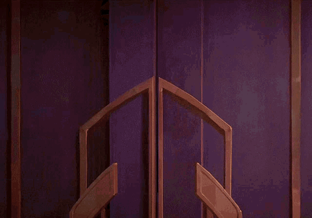 a woman in a purple dress is kicking a man in the face