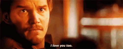 a close up of a man 's face with the words `` i love you too '' written on the bottom .