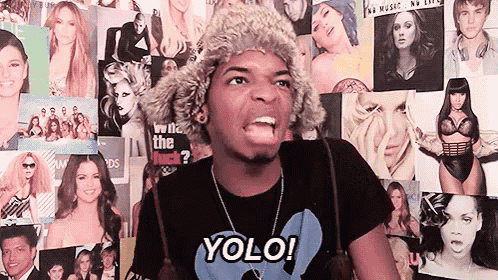 a man wearing a fur hat and a t-shirt that says " yolo "