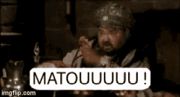 a man is sitting at a table with a sign that says matouuuu !