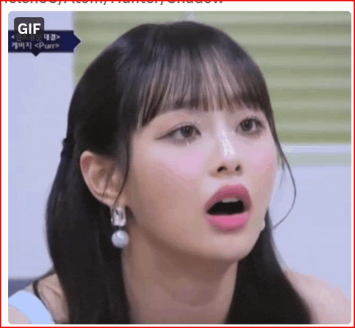 a close up of a woman 's face with her mouth open