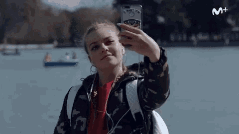 a woman is taking a selfie with a phone case that says i miss you