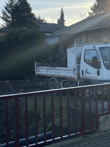 a white dump truck with a blue sticker on the side that says ' l' ambulance '