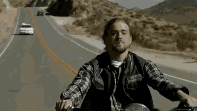 a man is riding a motorcycle on a highway .