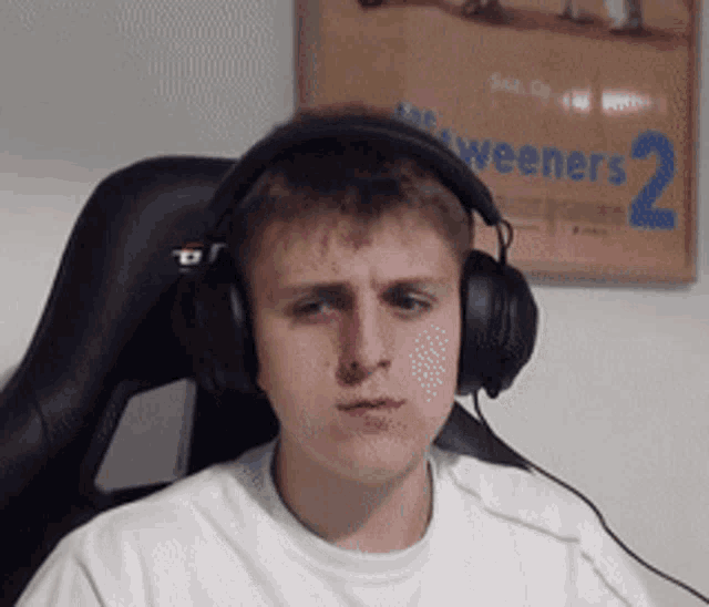 a man wearing headphones is sitting in front of a box that says weeners