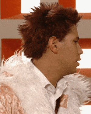 a man with red hair is wearing a white fur coat and a white shirt