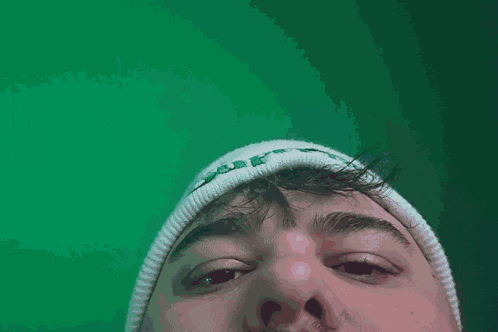 a close up of a person wearing a white hat