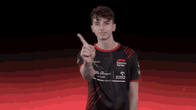 a young man wearing a black and red shirt that says esports series on it