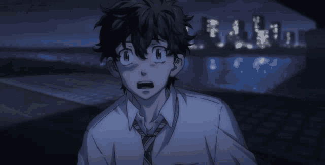 a man in a white shirt and tie is standing in front of a city at night