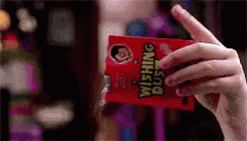 a person is holding a card that says wishing dust on it