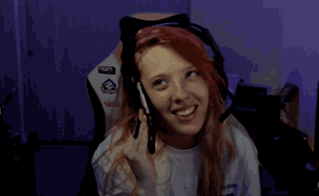 a woman sitting in a chair with a playstation logo on the back of her chair