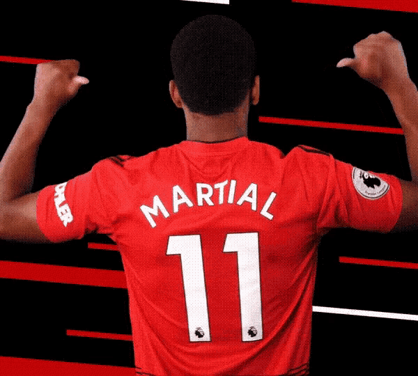 martial number 11 flexes his muscles in a red shirt