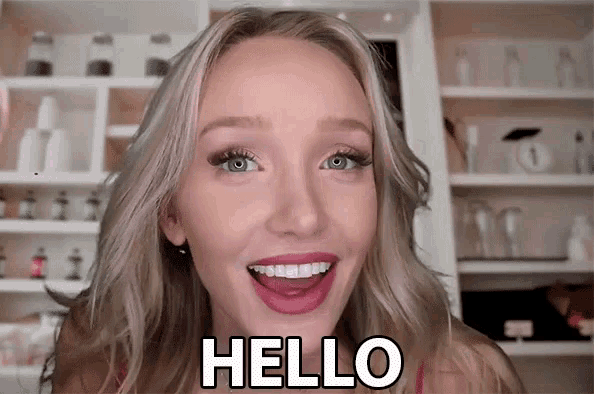a woman is smiling and says hello with her tongue out