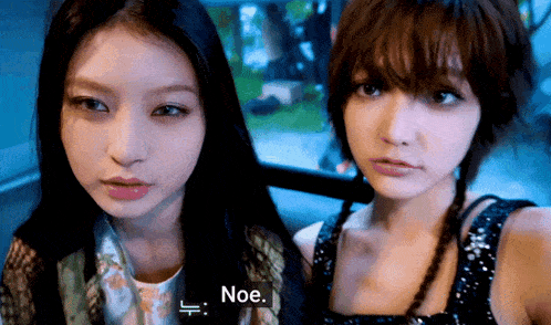 two women are standing next to each other and one of them has the word noe on her screen