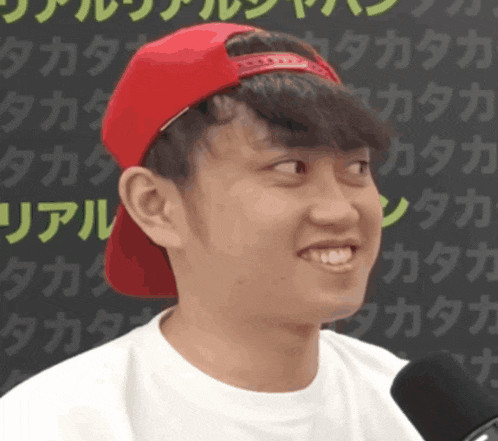 a young man wearing a red hat and a white shirt