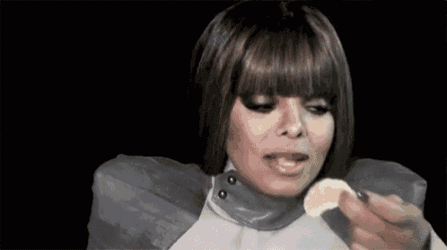 a woman with a fringe is eating a slice of lemon