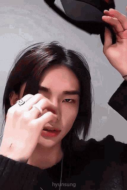 a close up of a person 's face with the name hyun sung on the bottom right