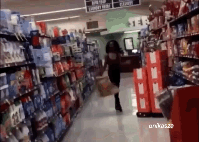 a woman is running through a grocery store aisle with a sign that says cleaning