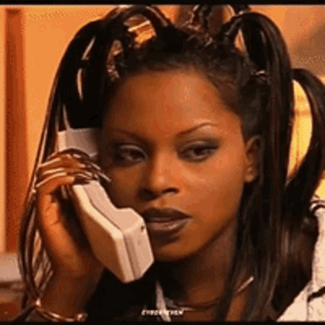 a close up of a woman talking on a phone with a caption that says " i 'm sorry "