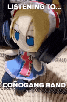 a stuffed doll is listening to a conogang band