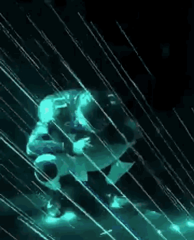 a person is standing in the rain in a dark room surrounded by glowing lights .