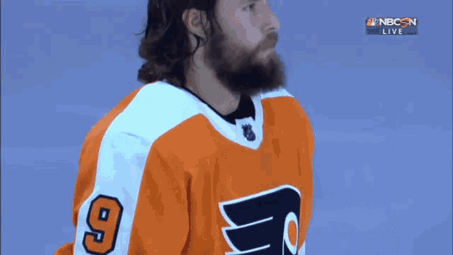 a man with a beard wearing a jersey with the number 9 on it
