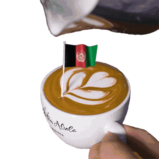 a cup of coffee with a flag of afghanistan on it