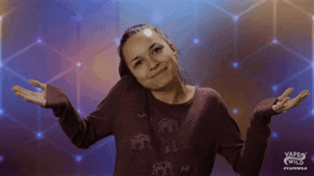 a woman with her arms outstretched is wearing a vape wild sweatshirt